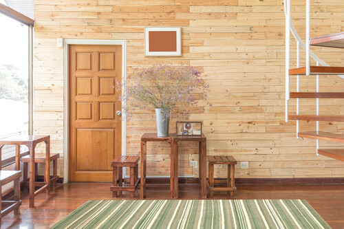 reclaimed wooden wall with wooden door table sets flowers zinc vase bright sunlight cozy warm interior atmosphere